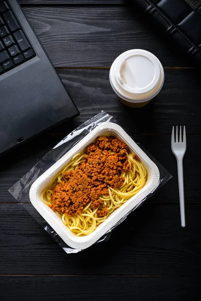 office lunch, frozen spaghetti bolognese on the table