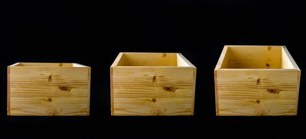 set of empty wooden boxes on black