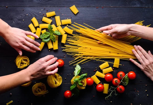 Female hands making fresh homemade pasta