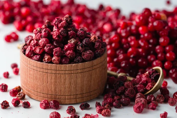 Sweet cranberries with dried cranberries closeup, dried lingonberry berry