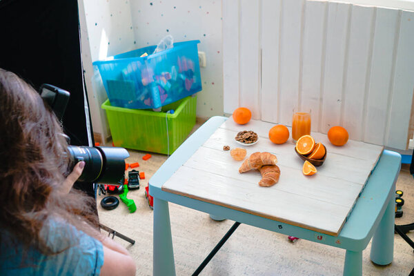 Food Blogger Closeup on female food photographer taking photo. Woman shooting food in kitchen, woman photographer at home
