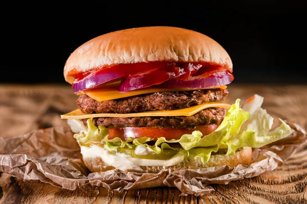 A classic style double cheeseburger with two beef patties, sauce, lettuce, cheese, pickles, and onions, Burger with double grilled beef