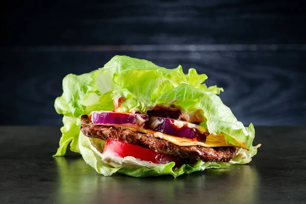 low-carb salad with beef Patty, diet lunch with beef patty, salad and tomatoes. Keto burger, lettuce wrapped burger