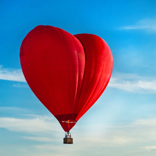 Balloon in the form of heart, red balloon heart in blue sky concept of love