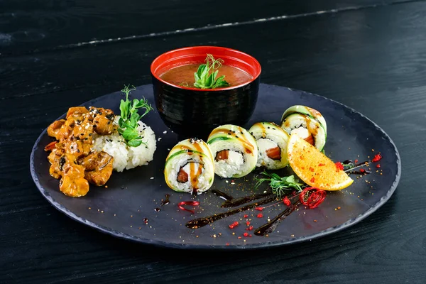 Japanese lunch set. Asian food set soup, sushi rolls and side dish, rice in a bowl with miso soup