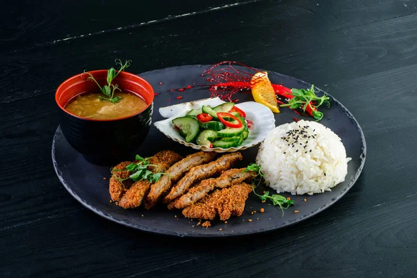 Japanese lunch set food. deep fried chicken or karake with teriyaki sauce, rice with miso soup and salad pickle as side dish, Set of japanese food