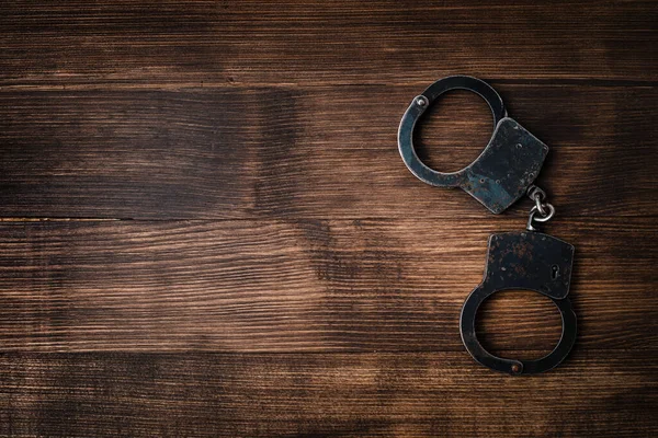 Steel Handcuffs Wooden Table Copy Space Idea Crime Punishment Attacker — Stock Photo, Image