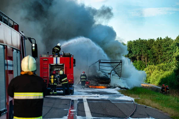 Firefighters put out the fire with foam in the car, fire engine extinguishes a fire on the road