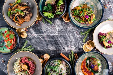Akdeniz Tabakları Sınırı masada. Uzayı karanlık ahşap yüzeyin üzerine kopyalayın. Ahşap masa boş fotokopi alanı ortada, tabaklar üstte.