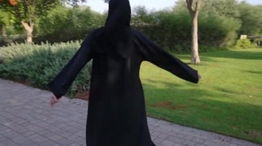 Dubai,Bae'deki Barsha parkında mornig yürüyüşü keyfi nde bulunan gülümseyen Arap kadın.