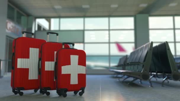 Travel suitcases featuring flag of Switzerland. Canadian tourism conceptual animation — Stock Video