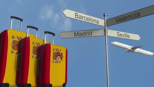 Travel baggage featuring flag of Spain, airplane and city sign post. Spanish tourism conceptual animation — Stock Video