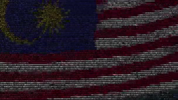 Auf einem Computerbildschirm weht eine malaysische Flagge aus Textsymbolen. konzeptionelle Schlupflöcher — Stockvideo