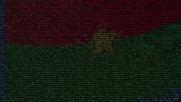 Ondeando la bandera de Burkina Faso hecha de símbolos de texto en una pantalla de computadora. Animación conceptual loopable — Vídeo de stock