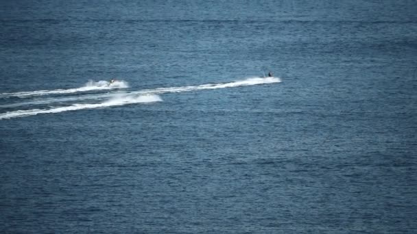 Three distant jet ski riders at sea, slow motion shot — Stock Video