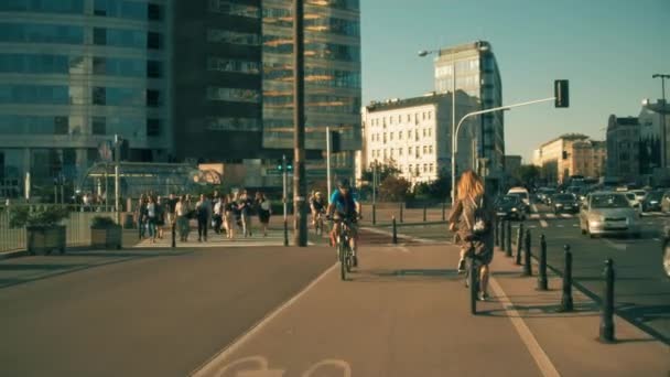 GARANTIA, POLÓNIA - 22 DE AGOSTO DE 2018. Jovem mulher pedalando ao longo da cidade ciclovia no centro da cidade — Vídeo de Stock