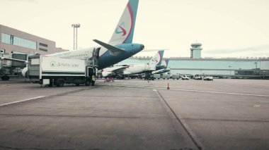 MOSCOW, RUSSIA - AUGUST 5, 2018. Commercial airplanes boarding at Domodedovo airport terminal clipart
