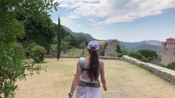 Mother and her baby daughter traveling with baby carrier backpack on vacation — Stock Video