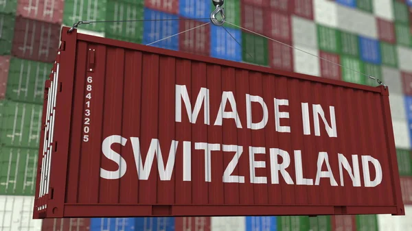 Contenedor de carga con leyenda MADE IN SWITZERLAND. Representación 3D relacionada con la importación o exportación de Suiza —  Fotos de Stock