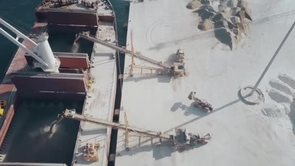 Aerial view of dry cargo ship and cement loaders in action — Stock Video