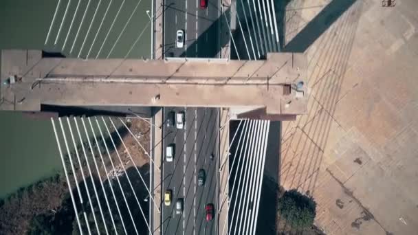 Aerial top-down view of cars moving along cable-stayed bridge — Stock Video