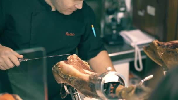 西班牙瓦伦西亚-2018年9月22日。男子切片贾蒙腿, 西班牙特产, 在梅尔卡多中央或中央市场 — 图库视频影像