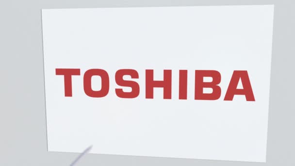 Archery arrow breaks glass plate with TOSHIBA company logo. Business issue conceptual editorial animation — Stock Video