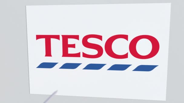 Archery arrow breaks glass plate with TESCO company logo. Business issue conceptual editorial animation — Stock Video