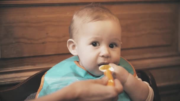 Divertida niña come comida poco apetitosa y frunce el ceño, primer plano — Vídeos de Stock