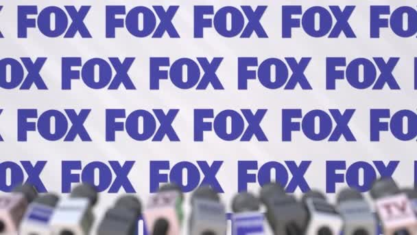 Пресс-конференция компании FOX, пресс-стенд с логотипом и микрофоном, концептуальная редакционная анимация — стоковое видео