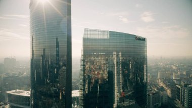 MILAN, ITALY - JANUARY 5, 2019. Aerial view of the UniCredit Tower reflecting the cityscape clipart