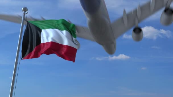 Verkehrsflugzeug landet hinter schwenkender kuwaitischer Flagge. Reise nach Kuwait konzeptionelle Animation — Stockvideo