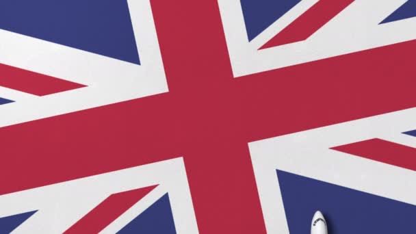 Коммерческий самолет на флаге Великобритании. Концептуальная 3D анимация — стоковое видео