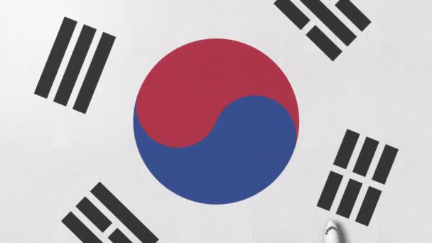 在韩国国旗上的飞机。与航班相关的概念3d 动画 — 图库视频影像