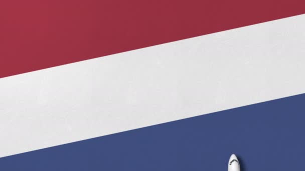 Airplane on the flag of the Netherlands. Flights related conceptual 3D animation — Stock Video