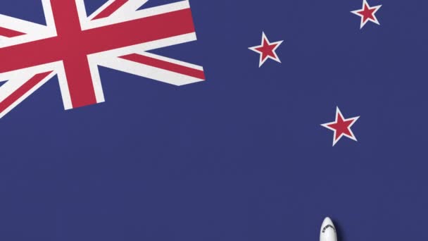 Commercial plane on the flag of New zealand. Tourism related conceptual 3D animation — Stock Video