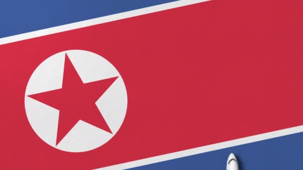 Commercial airplane on the flag of North Korea. Travel related conceptual 3D animation — Stock Video