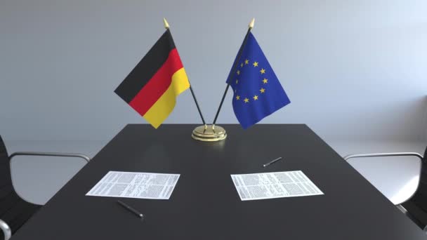 Flaggen von Deutschland und der Europäischen Union und Papiere auf dem Tisch. Verhandlungen und die Unterzeichnung eines internationalen Abkommens. konzeptionelle 3D-Animation — Stockvideo