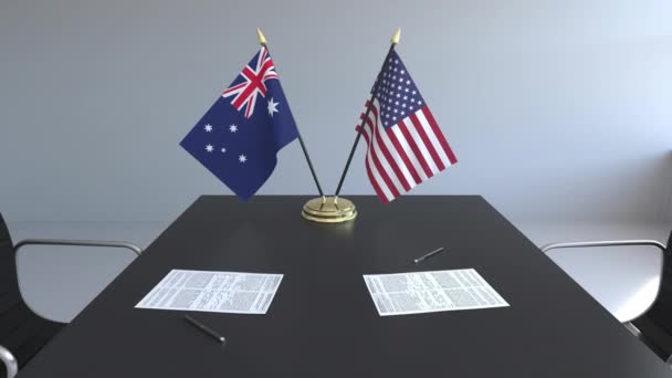 Banderas de Australia y Estados Unidos y documentos sobre la mesa. Negociaciones y firma de un acuerdo internacional. Animación 3D conceptual — Vídeos de Stock