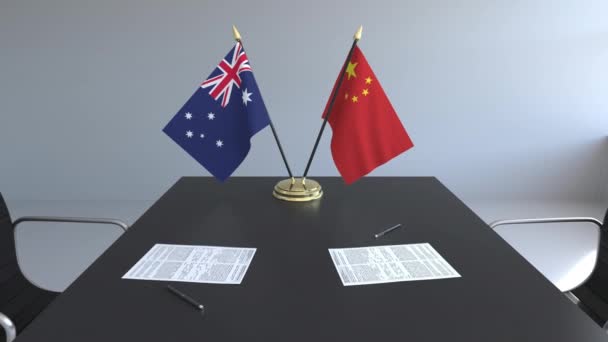 Avustralya ve Çin ve kağıtları masaya bayrakları. Müzakereler ve uluslararası bir anlaşma imzalama. Kavramsal 3d animasyon — Stok video