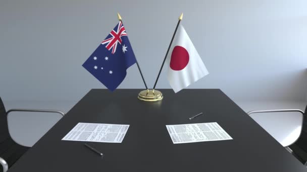 Bandeiras da Austrália e do Japão e papéis na mesa. Negociações e assinatura de um acordo internacional. Animação 3D conceitual — Vídeo de Stock