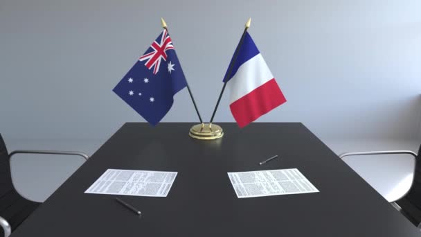 Flaggen von Australien und Frankreich und Papiere auf dem Tisch. Verhandlungen und die Unterzeichnung eines internationalen Abkommens. konzeptionelle 3D-Animation — Stockvideo