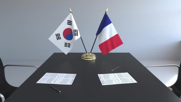 Flagi z Korei Południowej i Francji i dokumentacją na stole. Negocjacji i podpisywania umowy międzynarodowej. Koncepcyjne animacji 3d — Wideo stockowe