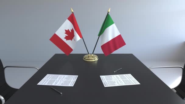 Flaggen von Kanada und Italien und Papiere auf dem Tisch. Verhandlungen und die Unterzeichnung eines internationalen Abkommens. konzeptionelle 3D-Animation — Stockvideo