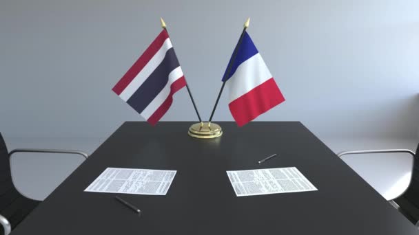 Banderas de Tailandia y Francia y papeles sobre la mesa. Negociaciones y firma de un acuerdo internacional. Animación 3D conceptual — Vídeos de Stock