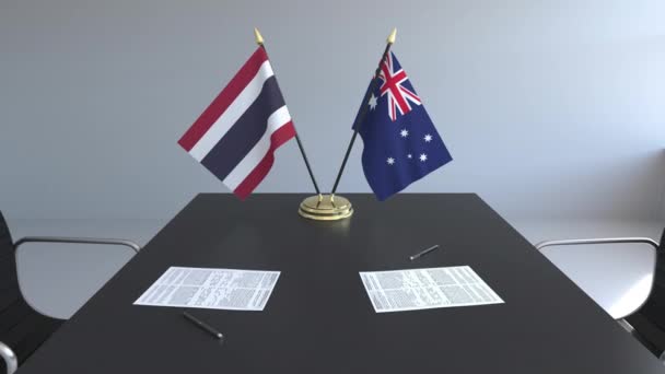 Banderas de Tailandia y Australia y papeles sobre la mesa. Negociaciones y firma de un acuerdo internacional. Animación 3D conceptual — Vídeos de Stock