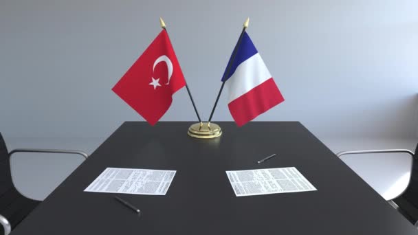 Banderas de Turquía y Francia y papeles sobre la mesa. Negociaciones y firma de un acuerdo internacional. Animación 3D conceptual — Vídeos de Stock