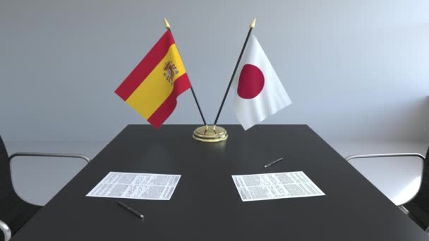 Banderas de España y Japón y papeles sobre la mesa. Negociaciones y firma de un acuerdo internacional. Animación 3D conceptual — Vídeos de Stock