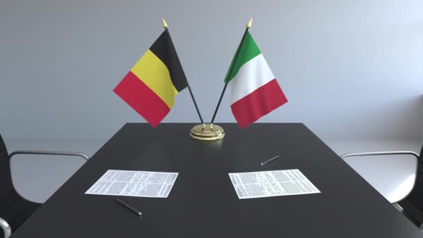 Drapeaux de Belgique et d'Italie et papiers sur la table. Négociations et signature d'un accord international. Animation 3D conceptuelle — Video