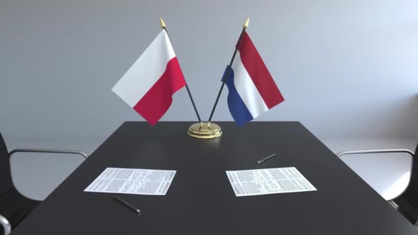 Flaggen Polens und der Niederlande und Papiere auf dem Tisch. Verhandlungen und die Unterzeichnung eines internationalen Abkommens. konzeptionelle 3D-Animation — Stockvideo